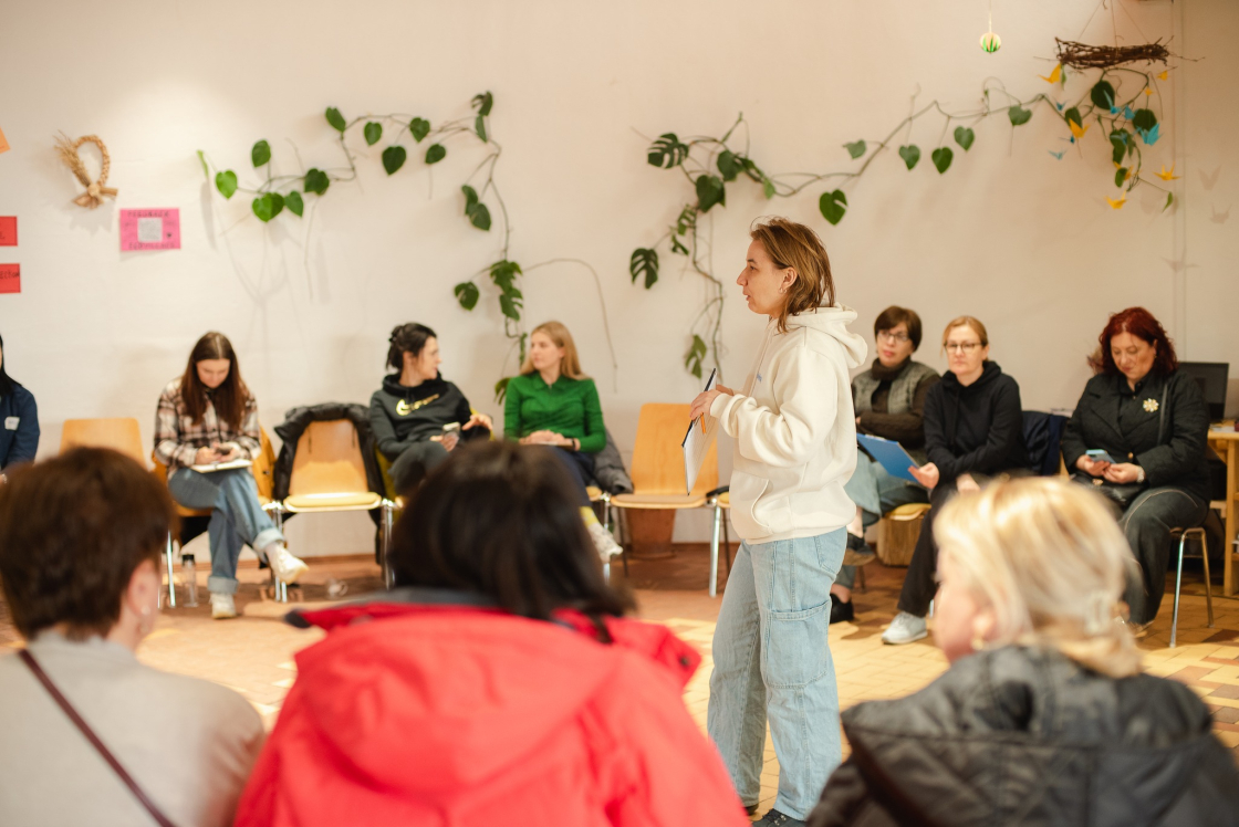 Participants of the international school listen to the trainer