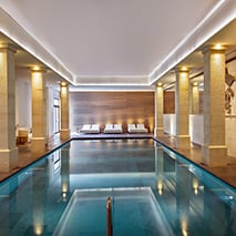 indoor swimming pool surrounded by marble columns at a spa