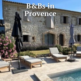 stone farm house with a patio chairs and outdoor pool