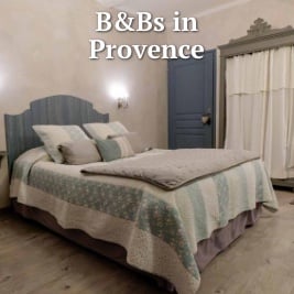 large bed with comfortable pillows in a soft blue and cream colour scheme