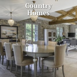 large dining table and chairs in large open space in stone country home