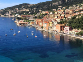 view of buildings along a shoreline with boats in the water