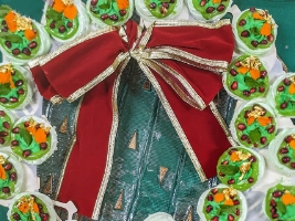 wreath constructed with small pots of green desserts