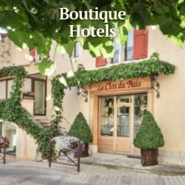 hotel entrance way in building with vines growing on railings and trees beside door