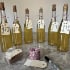 bottles of homemade orange wine lined up on a table