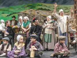 children and adults on a stage performing in amateur theatre