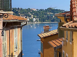 view of bay with boats from between buildings