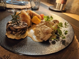 pork tenderloin slice with vegetables presented on a plate
