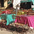 outdoor eating area with tables covered in bright tablecloths