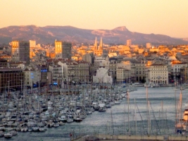 view of harbour filled with boats against a city skyline