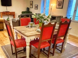 dining room with wood table and red upholstered chairs