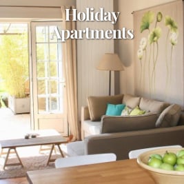 bright living room overlooking patio with lush greenery