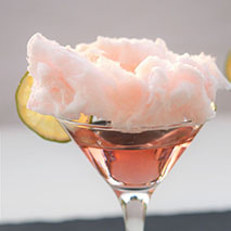 pink martini cocktail with cotton candy on the top