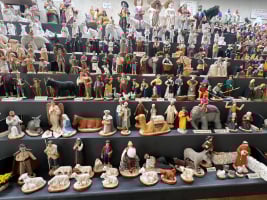 small painted clay figurines lined up on shelves