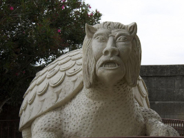 white stone statue of water monster with body like turtle and head like a humanized lion