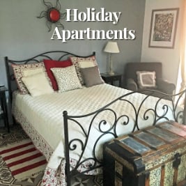 large bed in well appointed bedroom with neutral colours