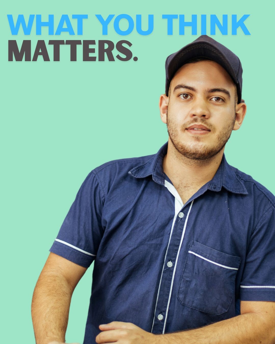 A person in a navy blue shirt with white trim stands against a mint green background, emphasizing the phrase 