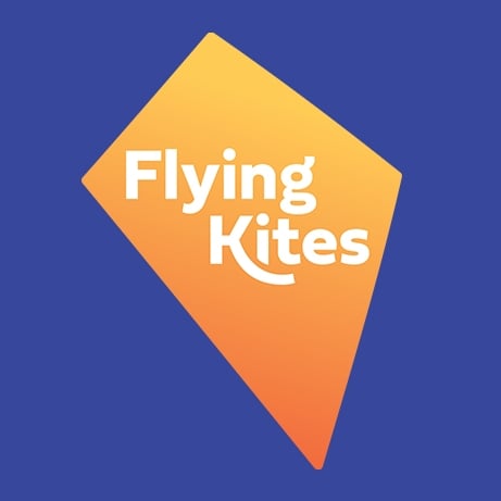 A blue background featuring an orange, kite-shaped graphic with the white text “Flying Kites” centered inside.