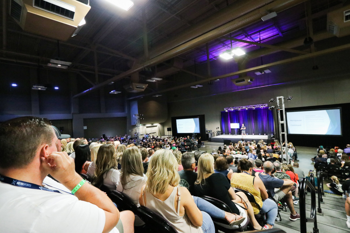 View of KetoCon main stage with crowd, speaker, and slide presentation
