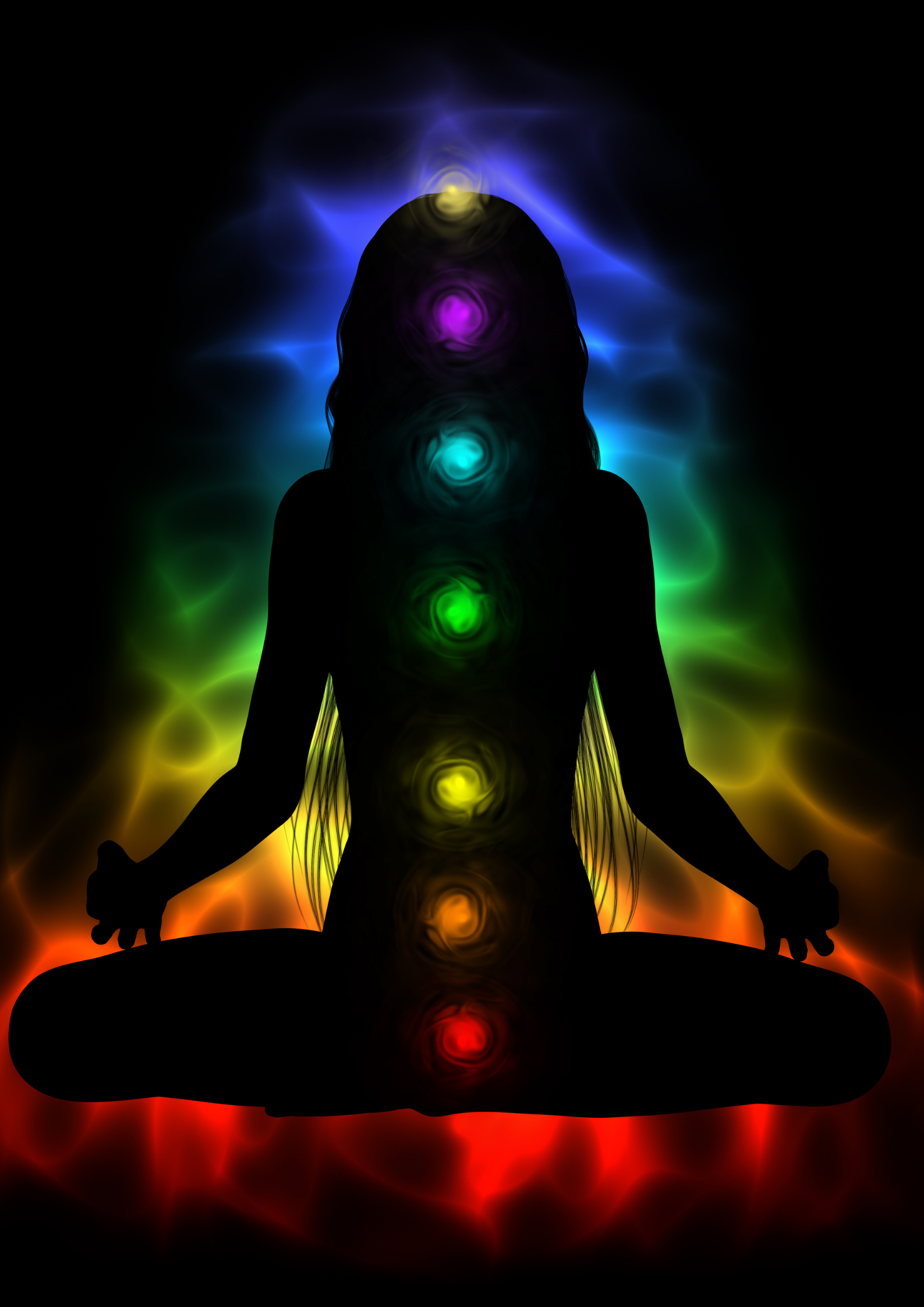 Dark form of a woman sitting meditating while the seven colours of the chakras illuminate her body. Root to Crown