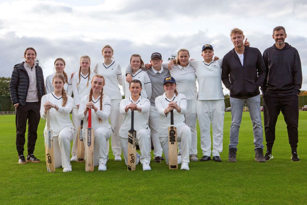 Group of young people in cricket clothing and Freddie Flintoff
