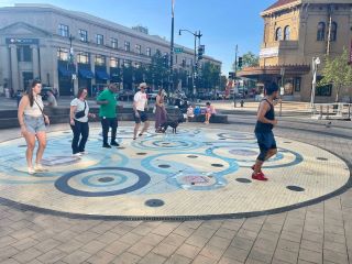 Councilmember Nadeau joins in a guided dance routine at Columbia Heights Plaza