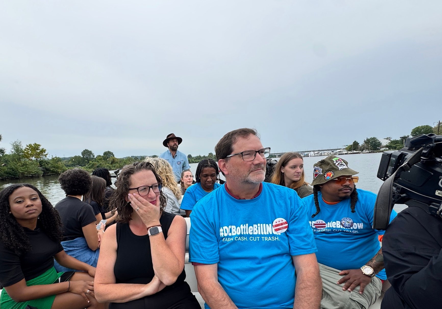Councilmember Brianne Nadeau and others wearing blue #DCBottleBillNow t-shirts on a boat tour of the Anacostia