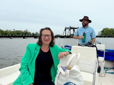 Councilmember Brianne K Nadeau on a boat on the Anacostia River with Trey Sherard, the Anacostia Riverkeeper