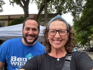 Councilmember Nadeau and Ben Williams pose for a selfie under a tent