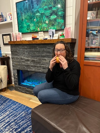 Councilmember Nadeau bites into an apple