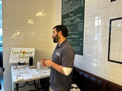 A staff member of Sunflower Bakery speaks at the new Tatte Bakery