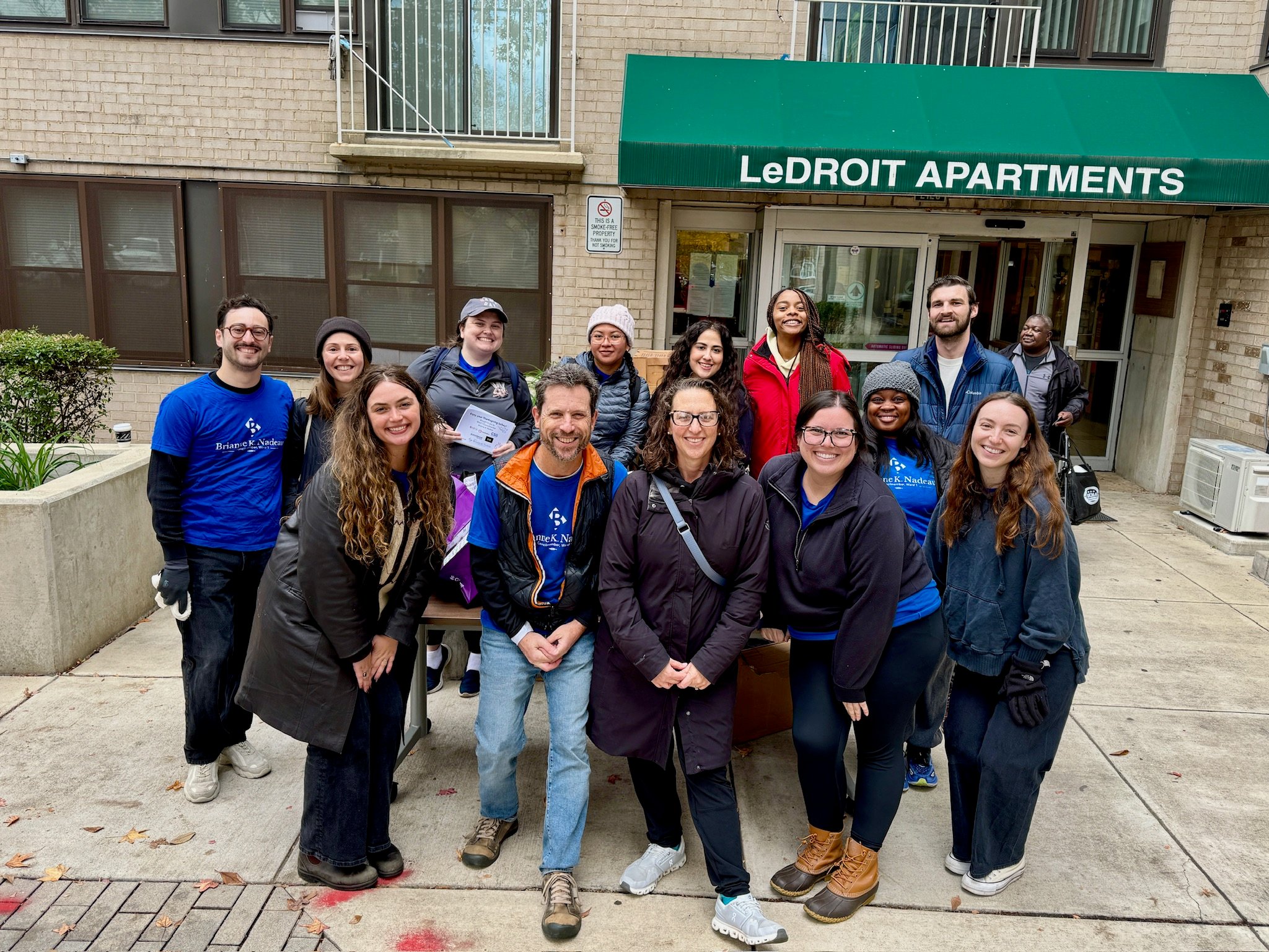 Office of Councilmember Brianne Nadeau's team gathers in front of LeDroit apartment building to distribute turkeys