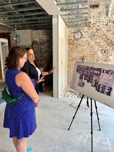 Councilmember Nadeau looks at a map of the new DC Center for LGBTQ+ Community in the space that is under construction