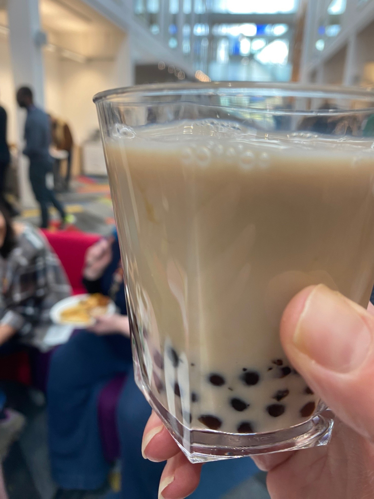 A glass of tea with tapioca beads at the bottom