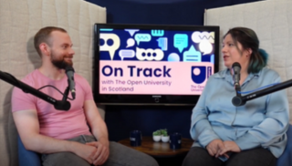 Two people speaking into microphones in front of an image bearing the words On Track with The Open University in Scotland.