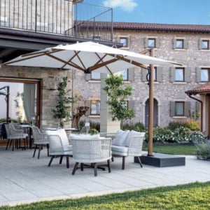 "Astro" Side-Arm parasol - a high spec, ultra premium parasol, shown here in a hotel setting.